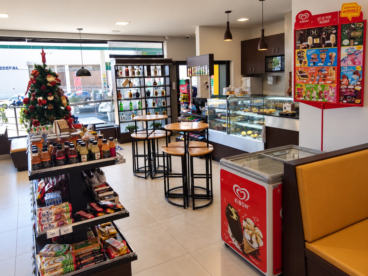 Salão da loja de conveniência com gôndolas, balcão e área de consumo